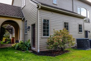 Two-story suburban home with beige vinyl siding