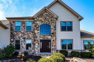 Two-story home with stone veneer and vinyl siding