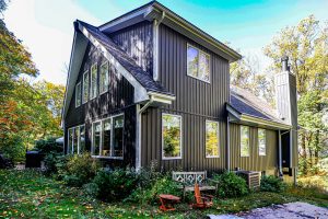 Dark gray house with vertical siding