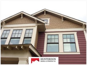 Double-hung windows on multi-story home with mixed siding colors